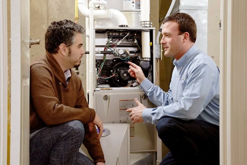 HVAC technician speaking with a homeowner